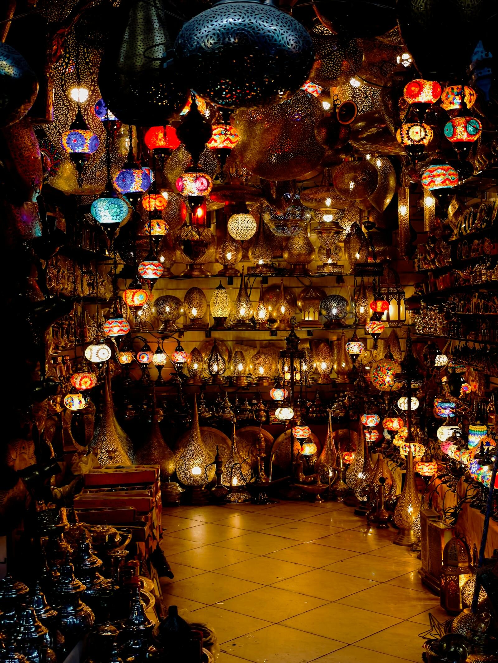 Brass and copper lanterns hanging in a Moroccan artisan workshop in Agadir