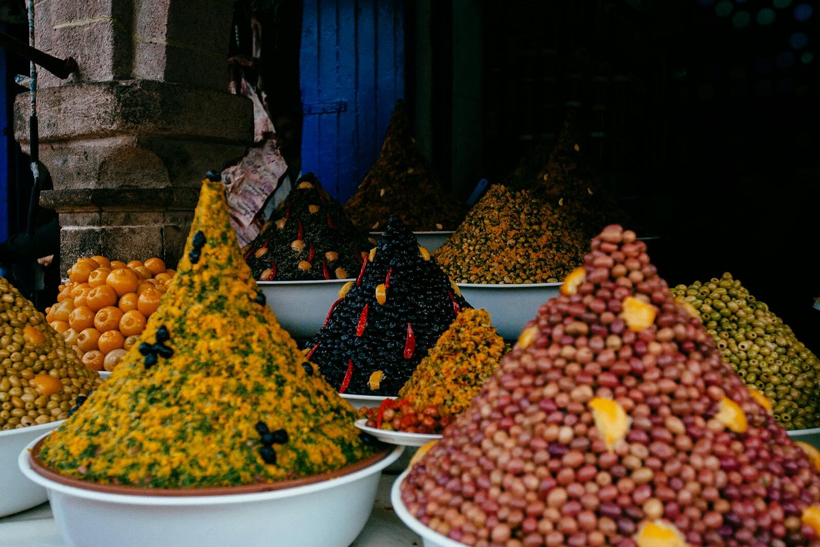 Olives and dates piled high at a Moroccan souk stall in Agadir