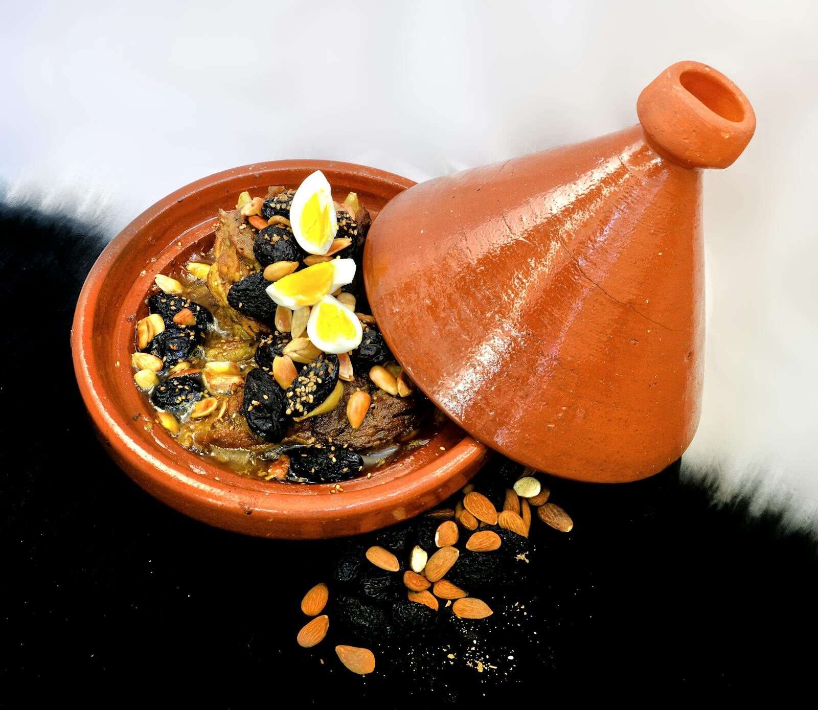 Lamb tagine with prunes and almonds, classic Moroccan presentation