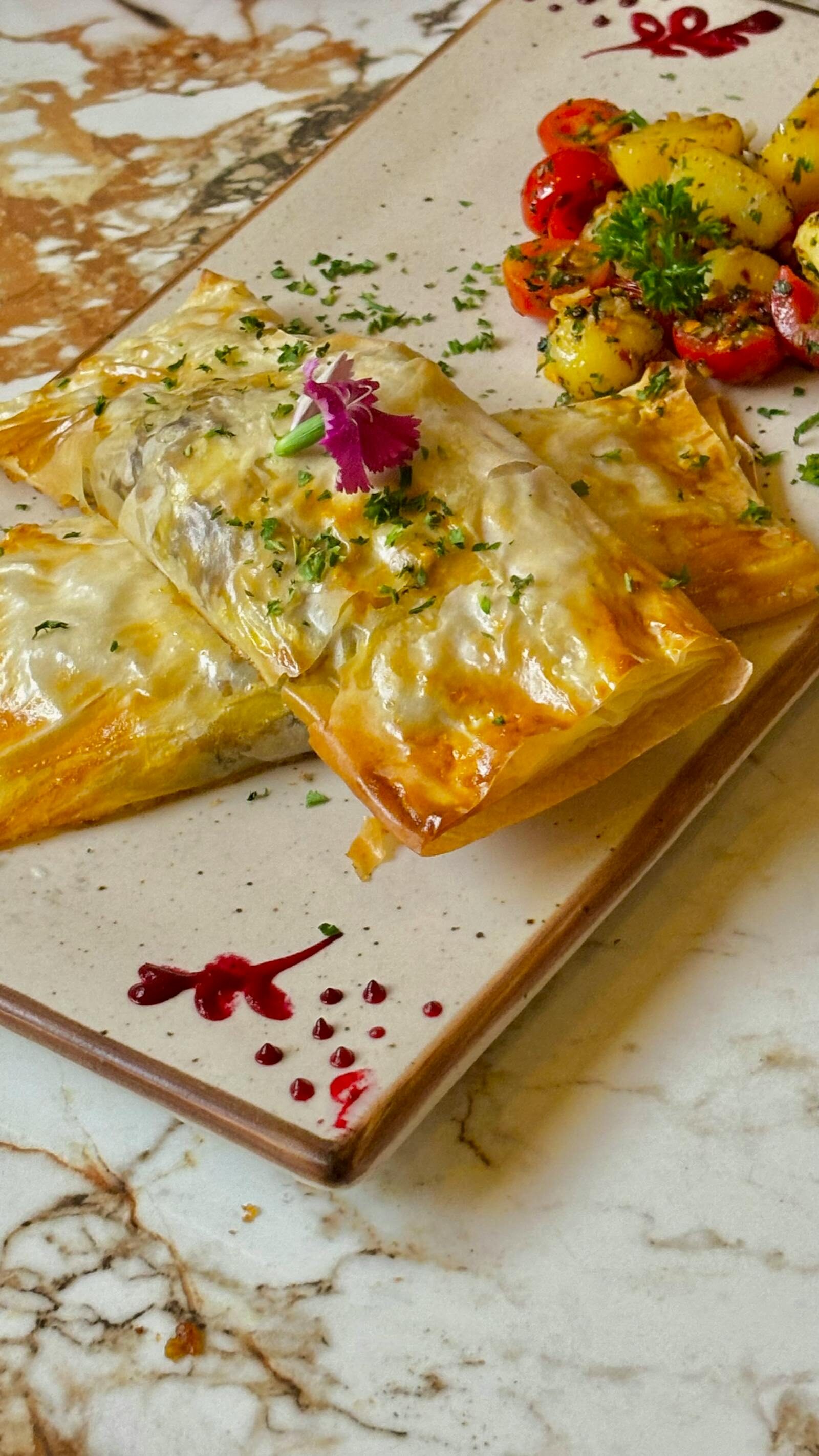 Moroccan pastilla, golden filo pastry with cinnamon and sugar dusting