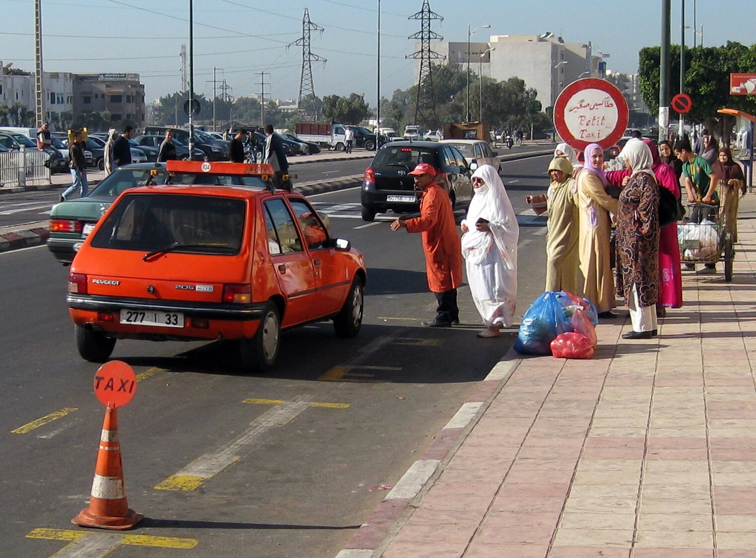 An orange petit taxi in Agadir — the licensed in-town and airport-run cab