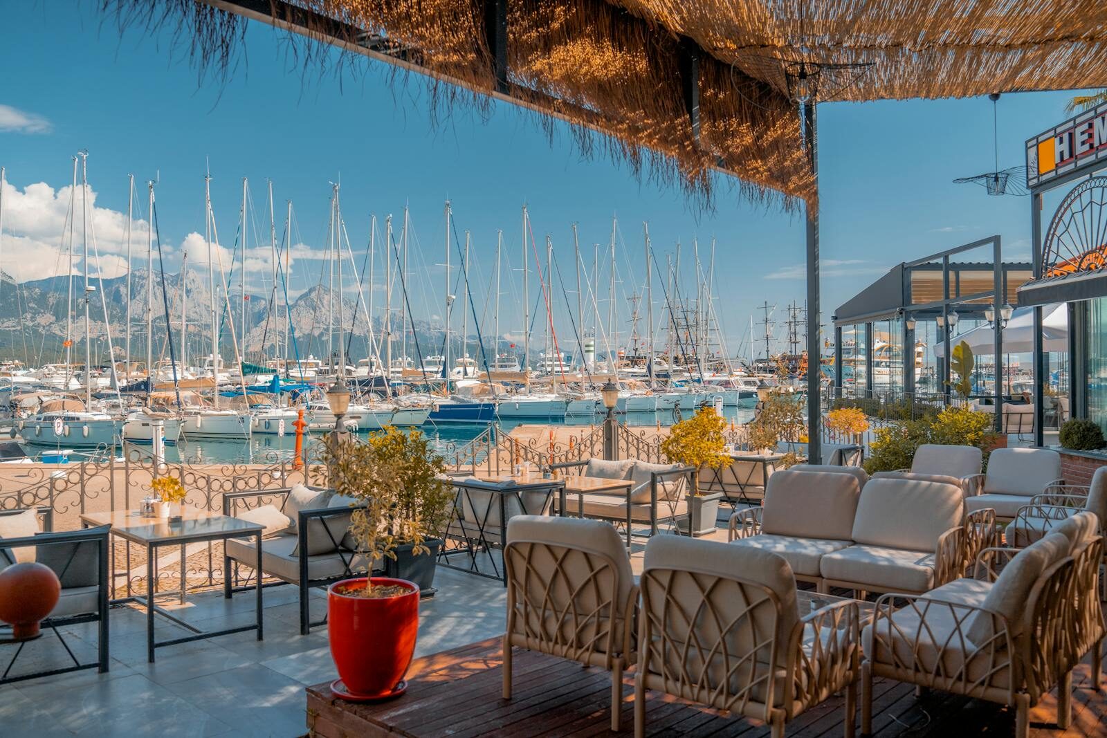 Mediterranean white-and-blue restaurant terrace at Les Blancs Agadir, with marina view