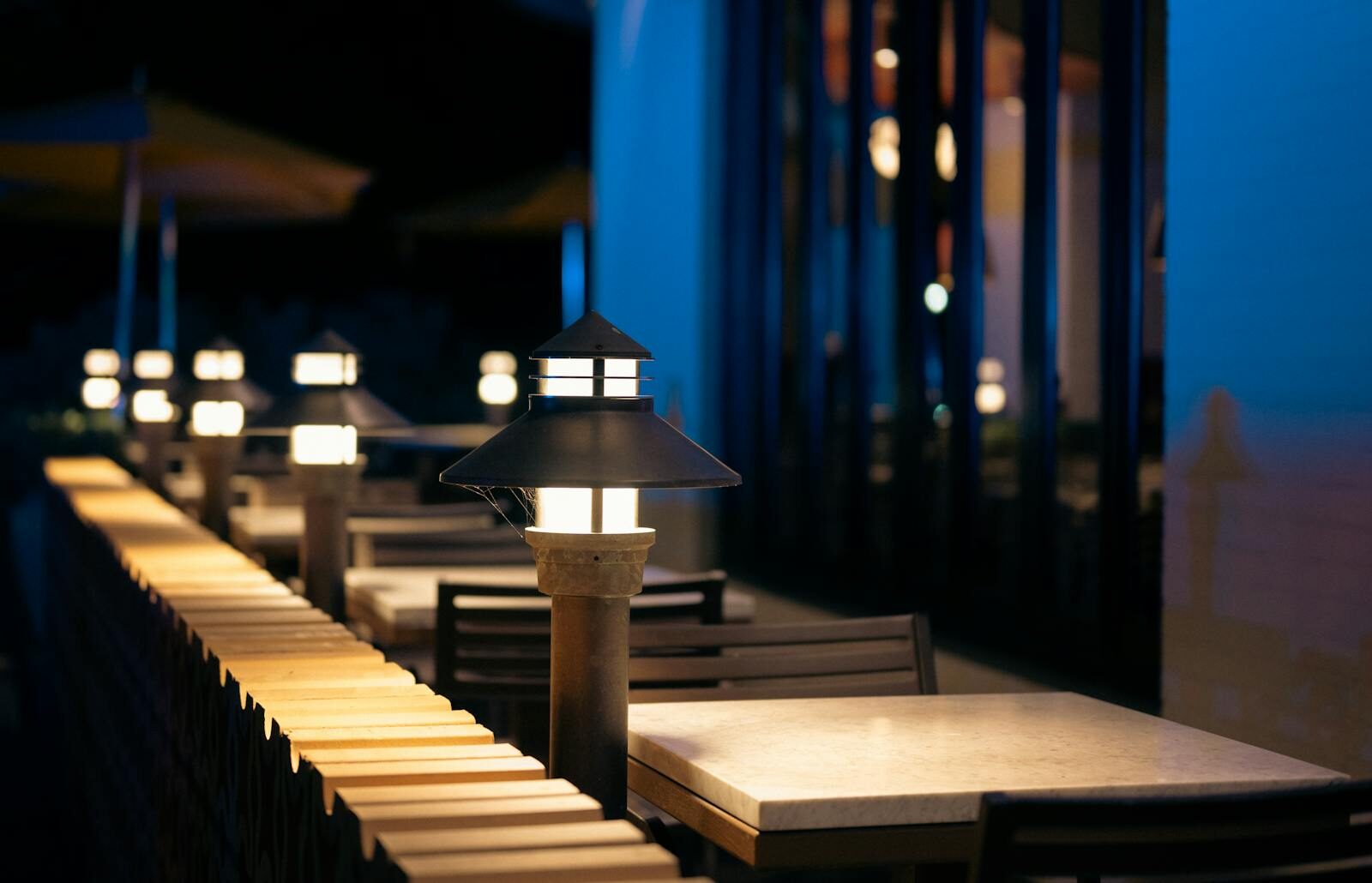 Restaurant terrace at dusk with golden lights — Les Blancs Agadir evening ambience