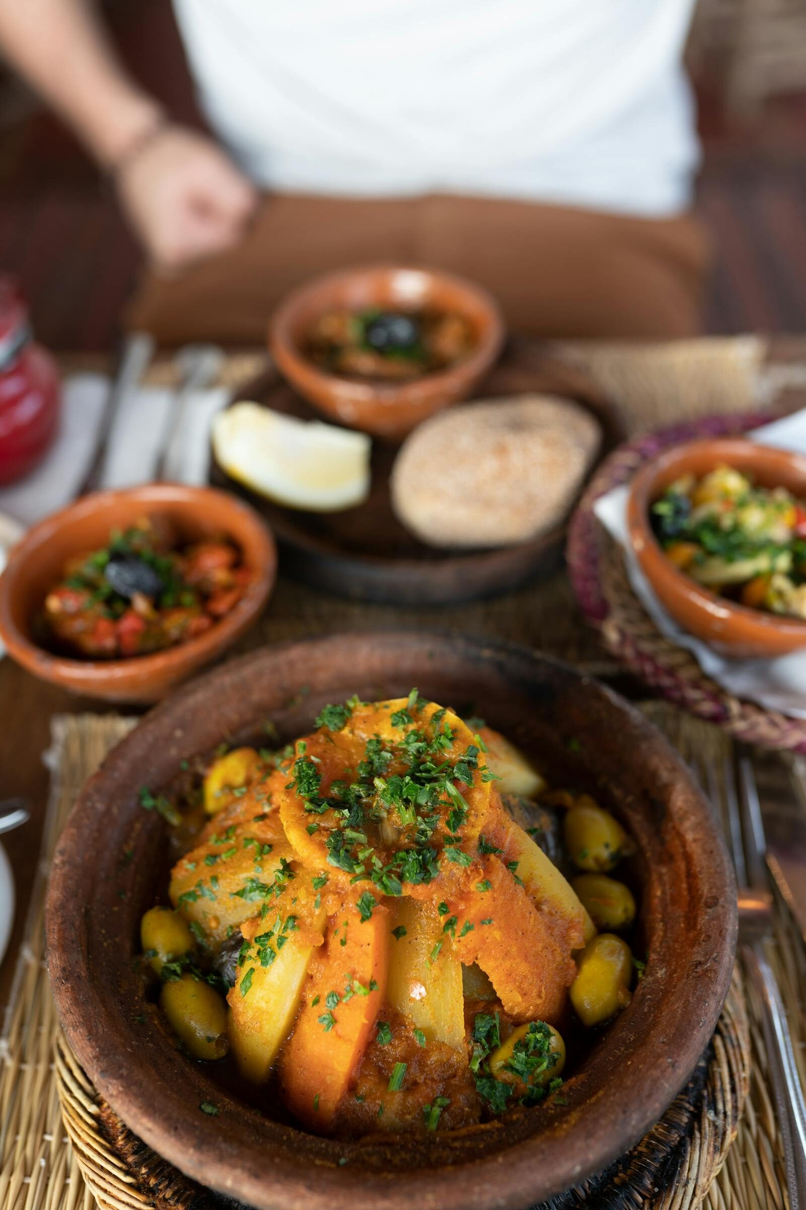 Vegetable tagine at Restaurant Rafiq Agadir, lid lifted with steam rising over colourful Moroccan stew