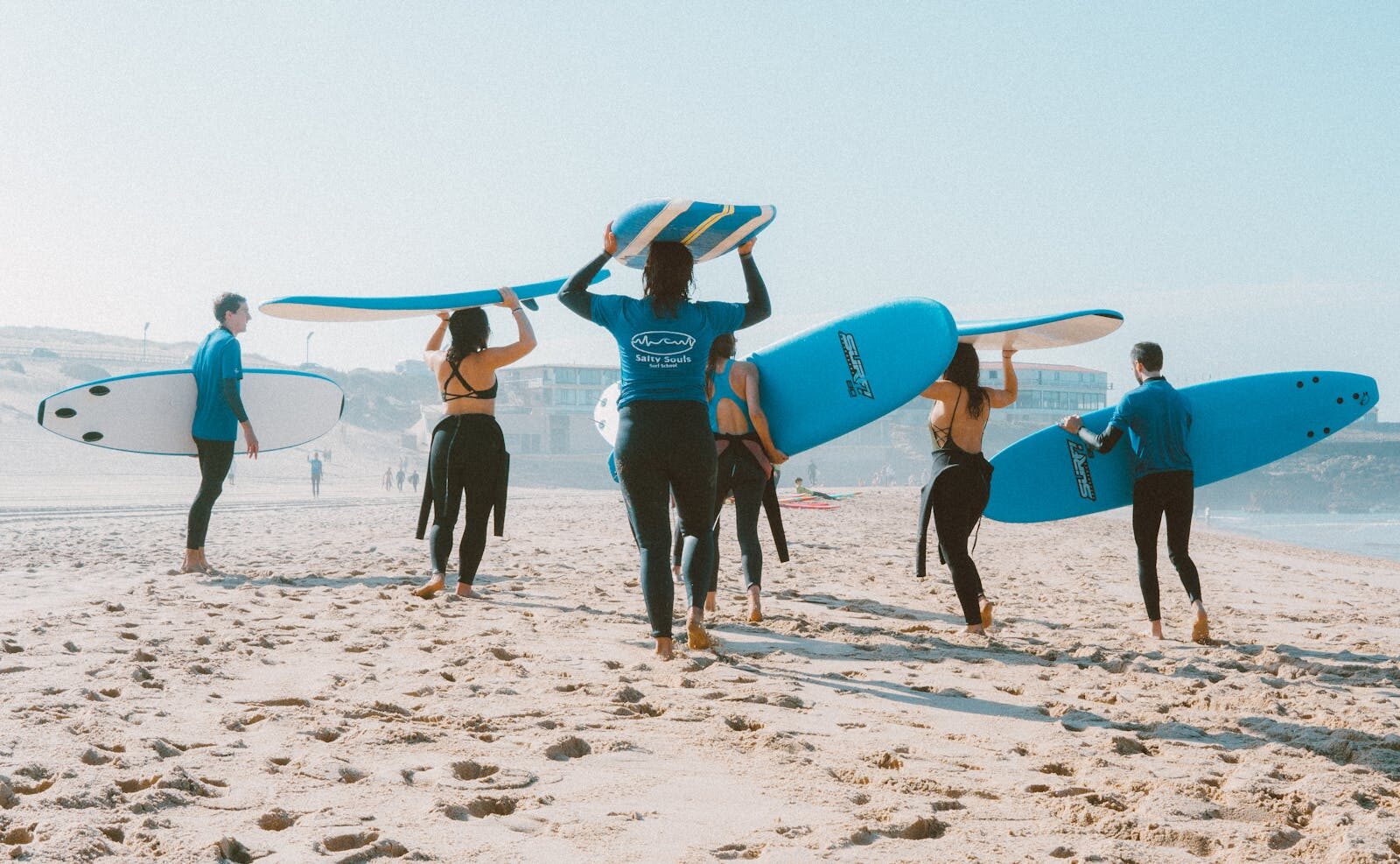 Soft-top beginner surfboards lined up on the sand at a Moroccan beach