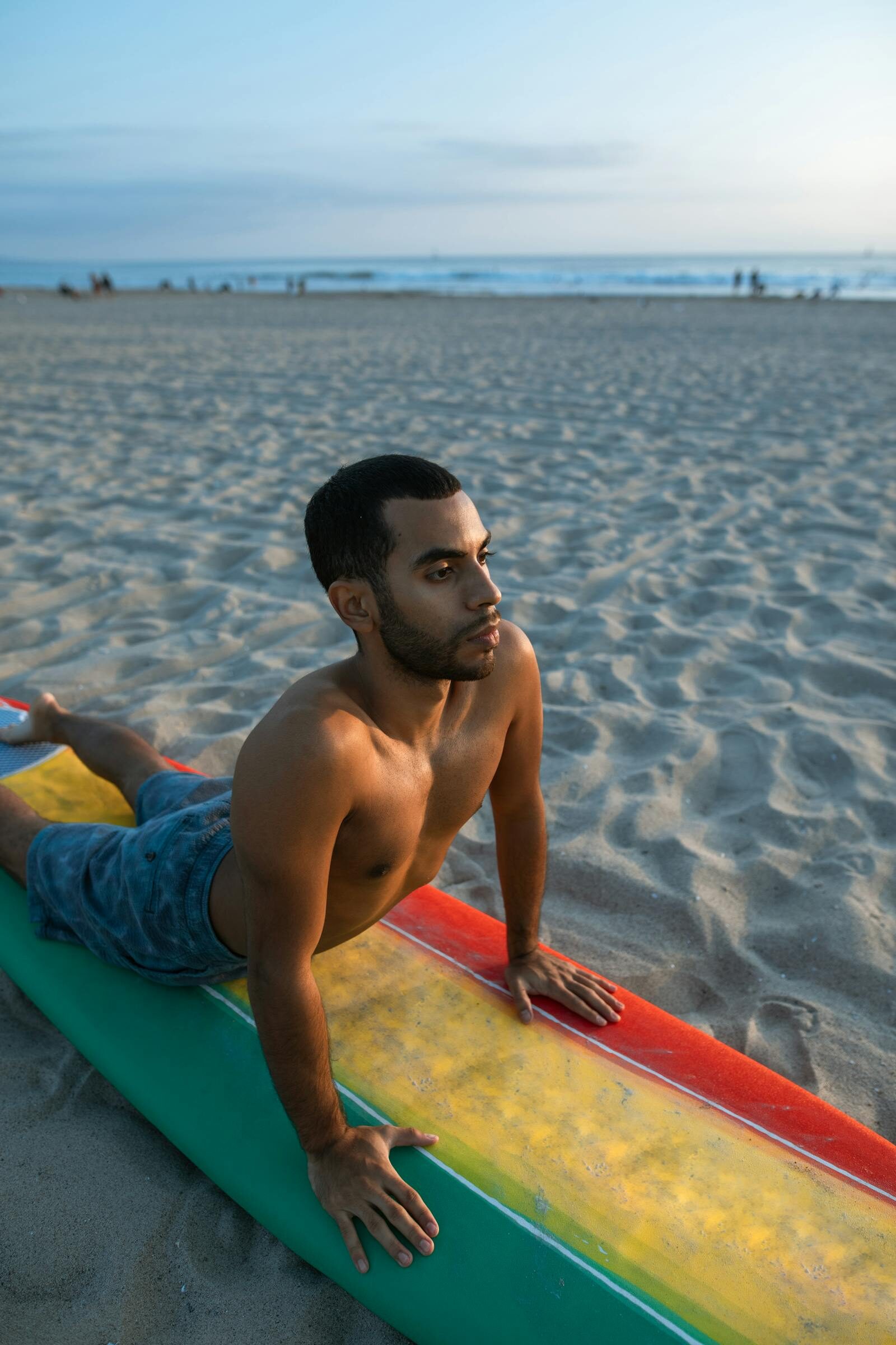Surf-camp yoga session on the beach — recovery stretching after morning surf